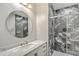 Bathroom featuring tiled shower with glass enclosure and round mirror at 1025 Riverland Woods Pl # 904, Charleston, SC 29412