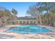 Inviting community pool with an adjacent clubhouse, surrounded by lush landscaping at 1025 Riverland Woods Pl # 904, Charleston, SC 29412