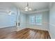 Open-concept dining area with hardwood floors, light-blue walls, chandelier, and connecting living room for seamless entertainment at 1025 Riverland Woods Pl # 904, Charleston, SC 29412