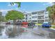 Modern condo building featuring balconies, well-maintained landscaping, and ample parking space for residents and guests at 1025 Riverland Woods Pl # 904, Charleston, SC 29412