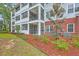 Exterior view of a condominium complex with screened in patios and manicured landscaping at 1025 Riverland Woods Pl # 904, Charleston, SC 29412