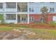 Exterior view of a condominium complex with screened in patios and brick facade at 1025 Riverland Woods Pl # 904, Charleston, SC 29412