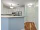Bright kitchen with white cabinetry, stainless steel appliances, and hardwood floors, offering modern style and functionality at 1025 Riverland Woods Pl # 904, Charleston, SC 29412