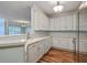 Bright kitchen featuring white cabinets, stainless steel appliances, and wood flooring at 1025 Riverland Woods Pl # 904, Charleston, SC 29412