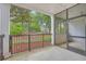 Enjoy views from this screened patio with black railing and trees in the background at 1025 Riverland Woods Pl # 904, Charleston, SC 29412