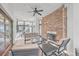 Covered patio with a stone fireplace and comfortable seating, perfect for relaxation at 1025 Riverland Woods Pl # 904, Charleston, SC 29412