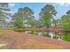 Scenic view of a community pond surrounded by mature trees and lush landscaping at 1025 Riverland Woods Pl # 904, Charleston, SC 29412