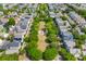 Extensive aerial view of a neighborhood with tree-lined streets, cross street, and various rooftops at 104 Hyacinth St, Summerville, SC 29483