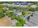 Aerial view of residential community with tree-lined streets, homes, and a small lake at 104 Hyacinth St, Summerville, SC 29483