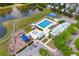 Aerial view of community amenities including a playground, pool, and parking near a pond at 104 Hyacinth St, Summerville, SC 29483
