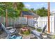 Relaxing backyard with gravel, a brick fire pit, seating, and white privacy fence at 104 Hyacinth St, Summerville, SC 29483