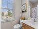 Bright bathroom with a clean vanity, a giraffe art piece, and a window providing natural light at 104 Hyacinth St, Summerville, SC 29483