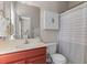 Cozy bathroom featuring a red vanity, mirror, and shower with a striped curtain at 104 Hyacinth St, Summerville, SC 29483
