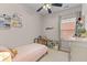Cozy bedroom with light pink bedding, decor shelving, and a window that offers plenty of natural light at 104 Hyacinth St, Summerville, SC 29483