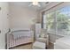 Charming Bedroom featuring a white crib, a glider, and a large window with natural light at 104 Hyacinth St, Summerville, SC 29483