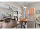 Bright dining area with hardwood floors features a pendant light fixture and an open view to the living room at 104 Hyacinth St, Summerville, SC 29483