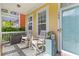 Inviting front porch with rocking chairs, a patterned rug, and a view of the charming neighborhood at 104 Hyacinth St, Summerville, SC 29483