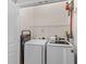 Efficient laundry room with modern washer and dryer set and storage shelving at 104 Hyacinth St, Summerville, SC 29483