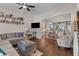 Cozy living room with hardwood floors, a comfortable sofa, and seamless access to the dining area at 104 Hyacinth St, Summerville, SC 29483