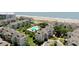 Beautiful aerial view of the property, community pool, and pristine beach at 9000 Palmetto Dr # C104, Isle of Palms, SC 29451