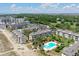 Expansive aerial shot of condos, pools, and greenspaces showcase an ideal location at 9000 Palmetto Dr # C104, Isle of Palms, SC 29451