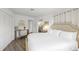 Bedroom with white walls, beige carpet, and a desk and mirror at 9000 Palmetto Dr # C104, Isle of Palms, SC 29451
