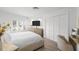 Bright bedroom with white walls, wood floors, and a large closet with shutter doors at 9000 Palmetto Dr # C104, Isle of Palms, SC 29451