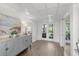 Bright hallway with a coastal sideboard, mirror, and double doors at 9000 Palmetto Dr # C104, Isle of Palms, SC 29451