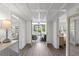 Inviting hallway leading to a screened-in porch and bedroom, showcasing beautiful wood flooring and natural light at 9000 Palmetto Dr # C104, Isle of Palms, SC 29451