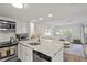 Open-concept kitchen with stainless appliances, granite countertops, and breakfast bar seating at 9000 Palmetto Dr # C104, Isle of Palms, SC 29451