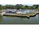 Aerial view of the community pool, clubhouse, and the waterway behind in a private and lush community at 1048 Wayfarer Ln, Charleston, SC 29412