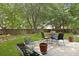 Landscaped backyard featuring patio furniture and a well-maintained lawn with mature trees in a private setting at 1048 Wayfarer Ln, Charleston, SC 29412