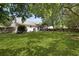 Large backyard with mature trees, well-manicured lawn, and outdoor living space for relaxation and recreation in a private setting at 1048 Wayfarer Ln, Charleston, SC 29412
