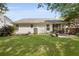 Expansive backyard featuring lush green lawn, mature trees, and a patio with outdoor seating for relaxation and entertaining at 1048 Wayfarer Ln, Charleston, SC 29412