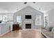 Cozy living room with a fireplace, vaulted ceilings, and abundant natural light at 1048 Wayfarer Ln, Charleston, SC 29412