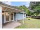 An angle view of the backyard patio with French doors leading inside the home at 1060 Oakcrest Dr, Charleston, SC 29412