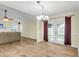 Spacious dining room with wood-look floors, French doors, and a stylish chandelier at 1060 Oakcrest Dr, Charleston, SC 29412