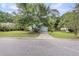 Charming single Gathering home featuring a well-manicured lawn, mature trees, and a private driveway at 1060 Oakcrest Dr, Charleston, SC 29412