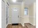 Bright foyer with a decorative front door, wood-look floors, and soft yellow walls with white trim at 1060 Oakcrest Dr, Charleston, SC 29412