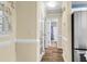 Hallway with beige walls, a glass door and tile floors leading to a bathroom with blue walls at 1060 Oakcrest Dr, Charleston, SC 29412