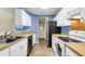 Functional kitchen with white cabinetry, wood-look countertops, and stainless steel appliances at 1060 Oakcrest Dr, Charleston, SC 29412