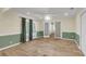 Bright living room with wood-look tile floors, recessed lighting, and multiple access points to other rooms at 1060 Oakcrest Dr, Charleston, SC 29412
