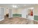 Bright living room with tile floors and doorways to other rooms, including one with a red accent wall at 1060 Oakcrest Dr, Charleston, SC 29412