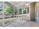 Enclosed screened-in porch with a view of the fenced-in backyard and green trees beyond at 1060 Oakcrest Dr, Charleston, SC 29412