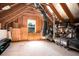 Unfinished attic with exposed rafters, insulation and a window for natural light at 1061 Ashley Gardens Blvd, Charleston, SC 29414