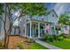 Inviting two-story home with a cozy front porch, lush landscaping, and a charming American flag at 1061 Ashley Gardens Blvd, Charleston, SC 29414