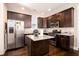 Modern kitchen with stainless steel appliances, granite countertops, and dark wood cabinetry at 1061 Ashley Gardens Blvd, Charleston, SC 29414