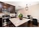 Well-appointed kitchen with stainless steel appliances, granite island, and dark wood cabinetry at 1061 Ashley Gardens Blvd, Charleston, SC 29414
