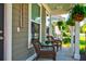 Charming front porch with cozy seating, hanging ferns, and a welcoming atmosphere at 1061 Ashley Gardens Blvd, Charleston, SC 29414