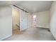 Bedroom with skylight, sliding barn door, and neutral decor creating a serene space at 1115 Shadow Lake Cir, Mount Pleasant, SC 29464